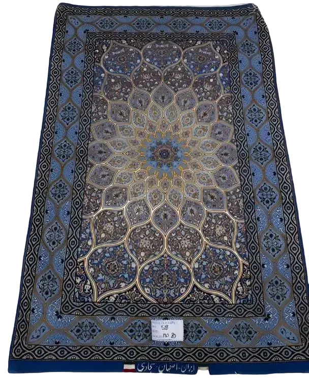 "Hand-knotted Persian rug made of wool and silk, featuring a luxurious design with intricate patterns. Measuring approximately 130 cm x 83 cm (4.2 x 2.7 feet), the rug is crafted in Isfahan, Iran. It has a knot density of 810,000 knots per square meter and is new, woven by the skilled weaver Sajadie. The rug’s blend of wool and silk provides both durability and elegance."